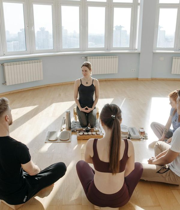 Person meditating peacefully after a cardio session, sunlit room.